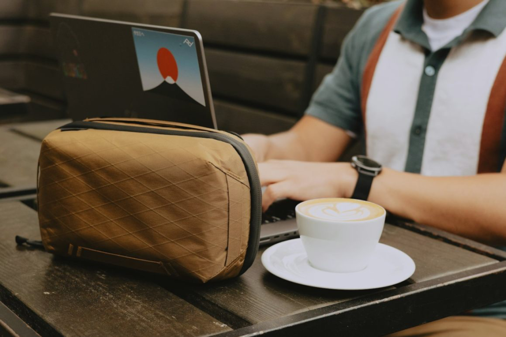 Peak Design Tech Pouch open showing cables and chargers in internal compartments